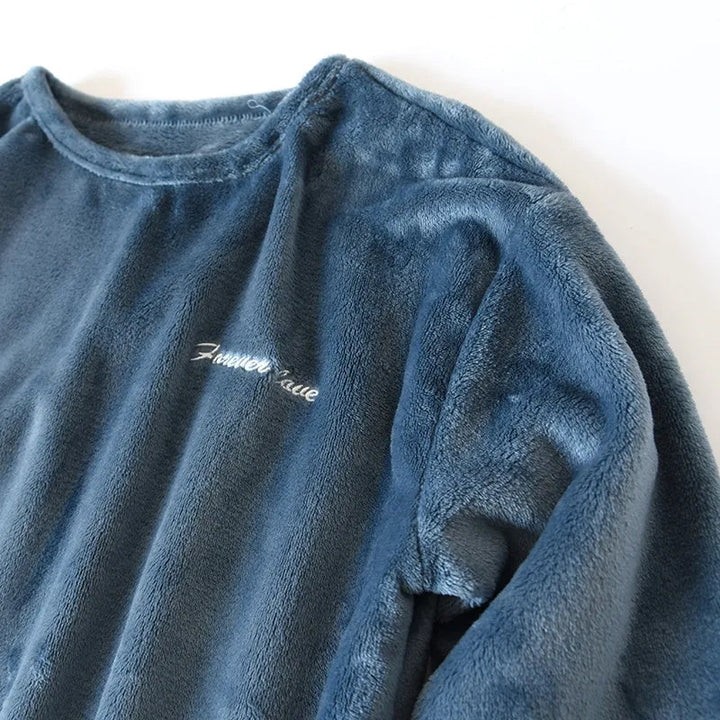 Side angle view of men's winter loungewear pants and top