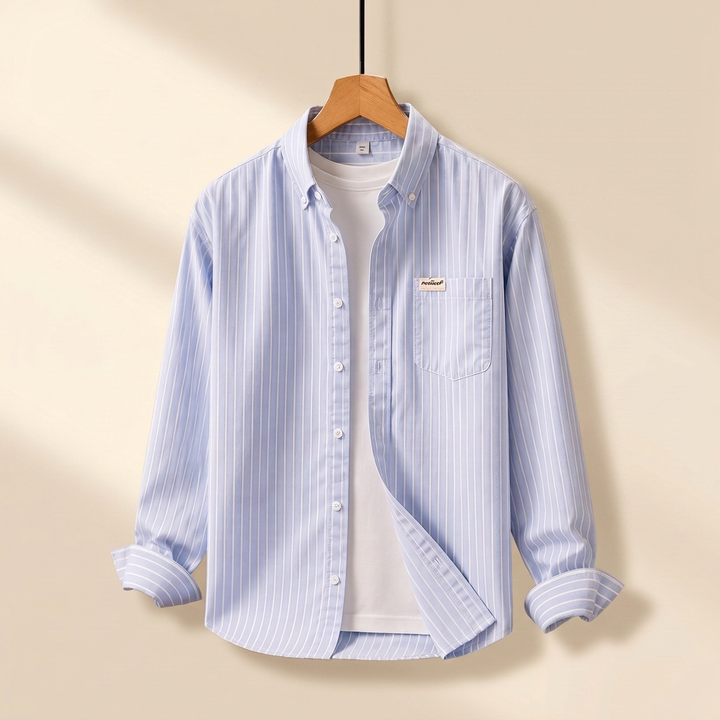 Light blue striped long sleeve button-up shirt hanging on a wooden hanger