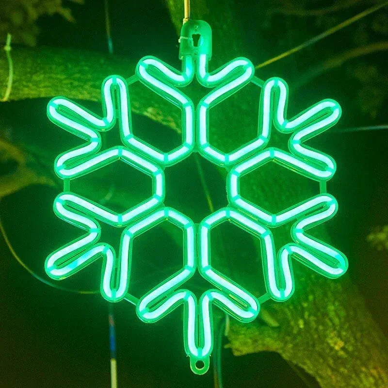 Winter lighting display showing glowing led snowflake string lights against a dark evening background.
