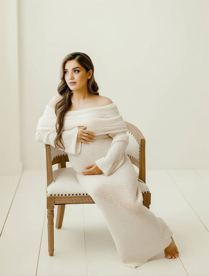 Pregnant woman wearing a white long sleeve pregnancy wear dress