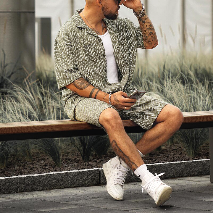 Man seated outdoors wearing the airy men's geometric print summer coordinating set