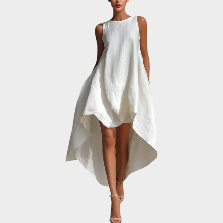 Front view of a woman wearing a white sleeveless high-low midi dress