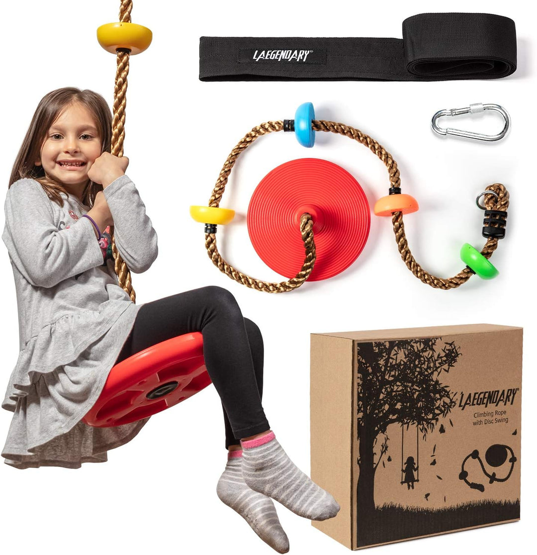 Girl sitting on a red disc tree swing with colorful climbing rope and accessories