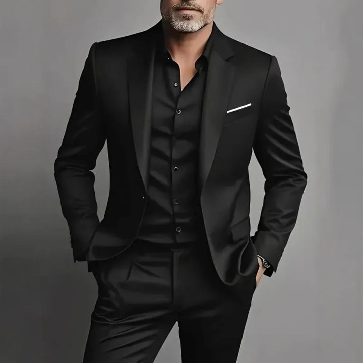 Man wearing a black slim fit suit set with matching blazer and trousers