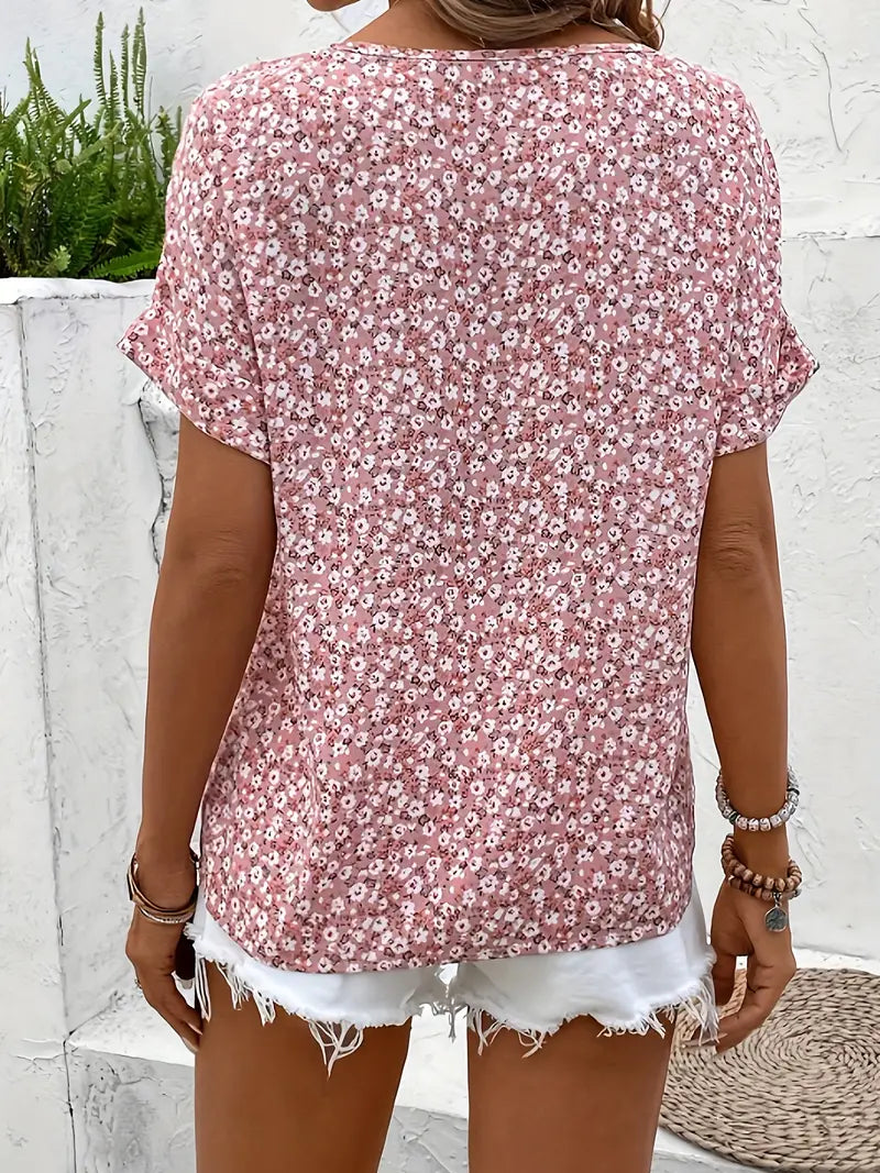 Back view of a woman wearing a pink floral short-sleeve blouse