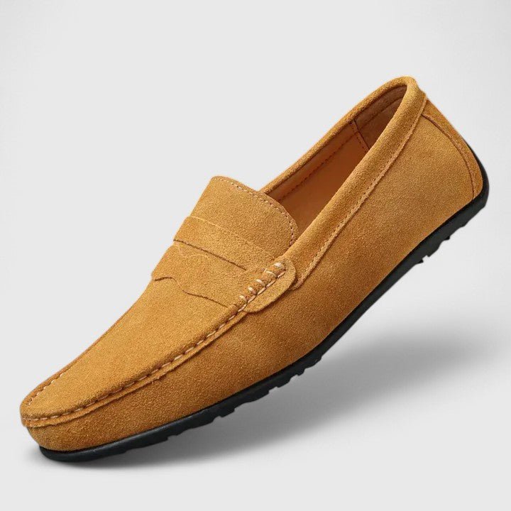 Pair of stylish men's slip-on shoes neatly arranged on a neutral surface