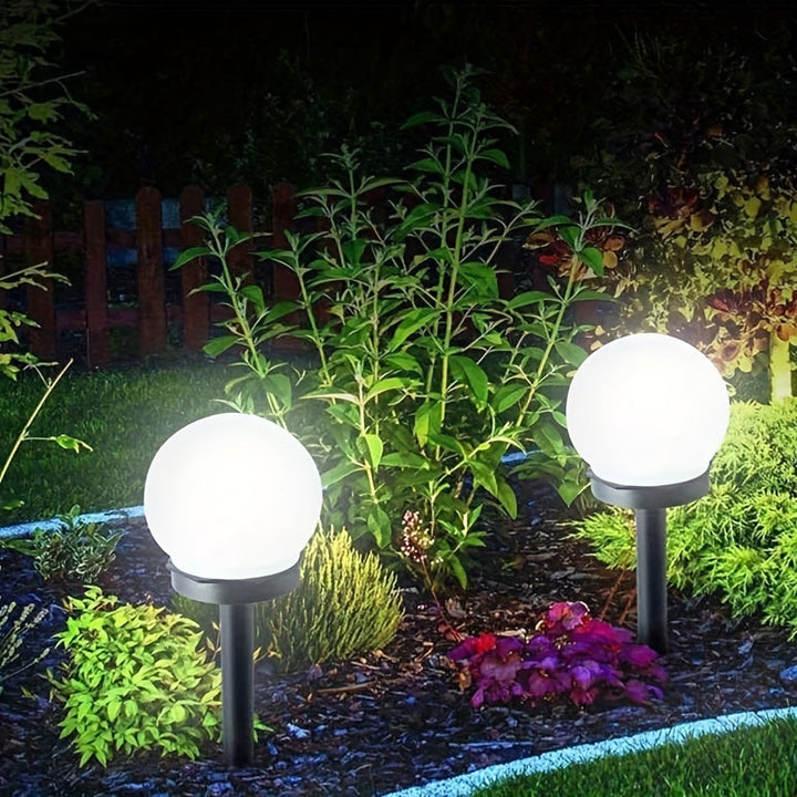 Detail shot of the integrated solar panel on top of a spherical LED landscape light.