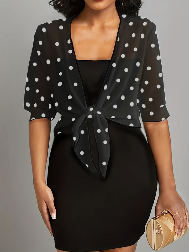 Woman wearing black polka dot tie-front blouse