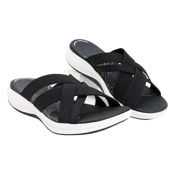 Black orthopedic walking sandals with cross straps and white sole