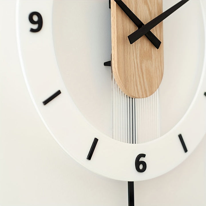 Modern wooden and acrylic silent pendulum wall clock hanging on a living room wall