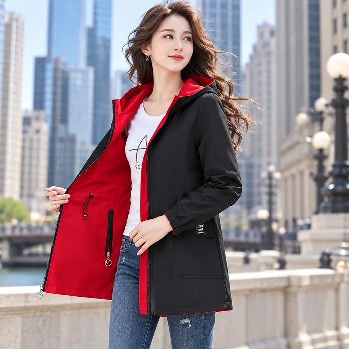 Woman wearing a black and red reversible parka outdoors in the city
