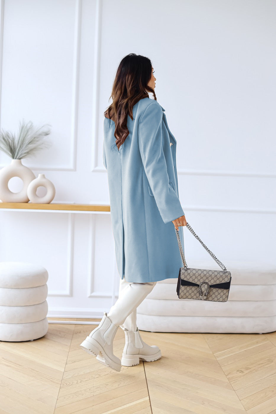 Close up of fabric and belt buckle on long trench coat