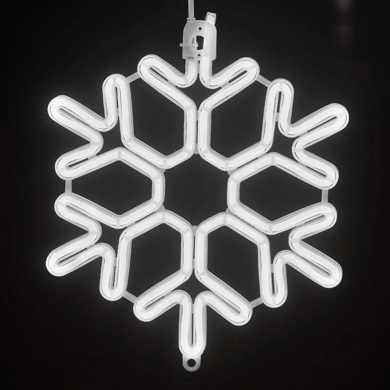 Close-up view of warm white LED snowflake string lights featuring intricate winter frost designs.