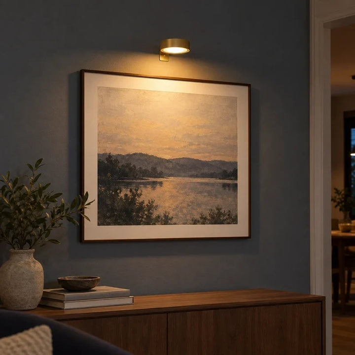 Sleek metallic wall sconce and LED picture light for paintings and photographs