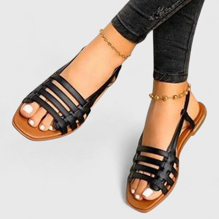 Women wearing black orthopedic slingback sandals paired with jeans