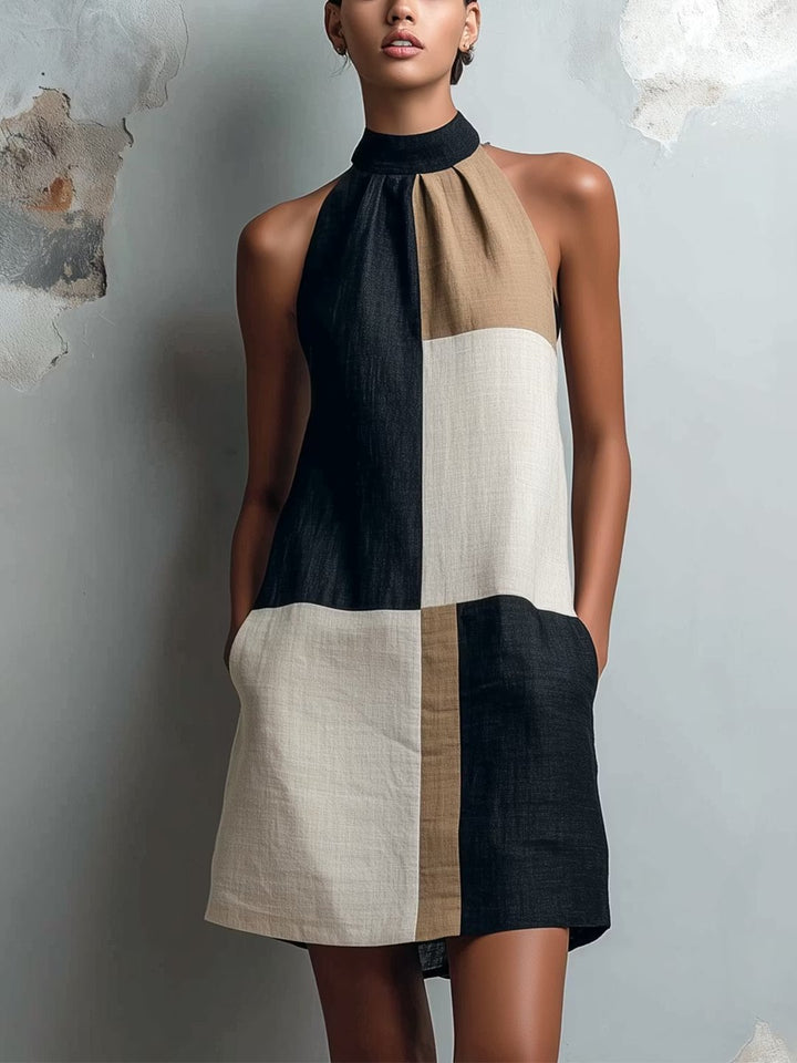 Front view of a woman wearing a colorblock halter mini dress