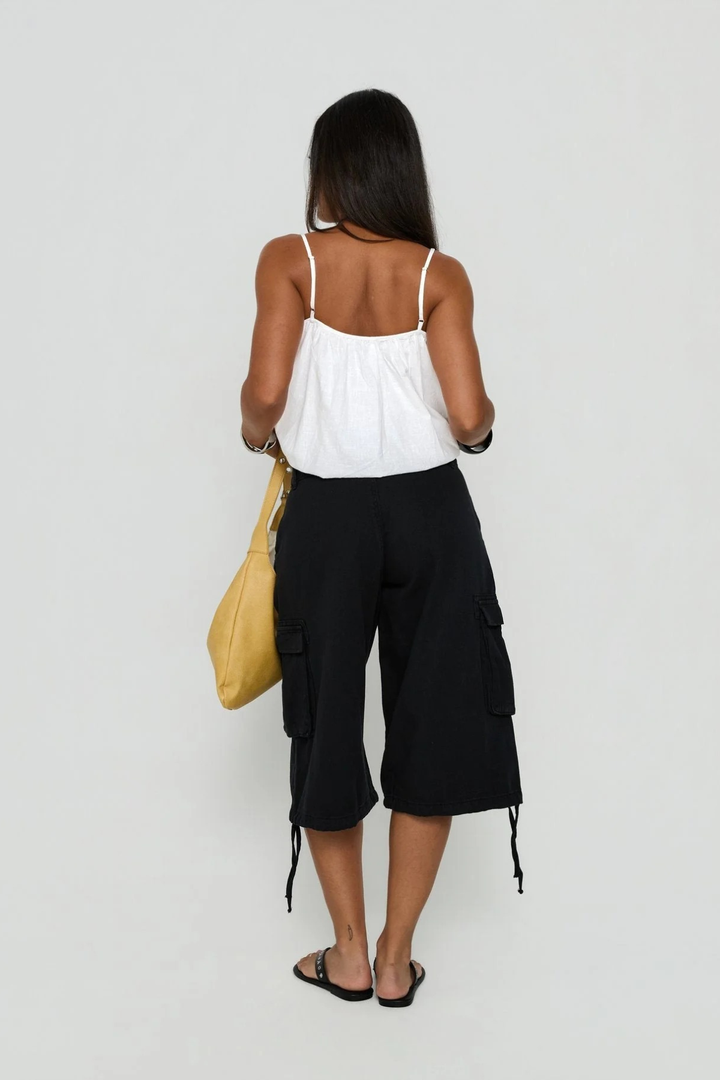Detailed shot of waistband and button closure on women's shorts