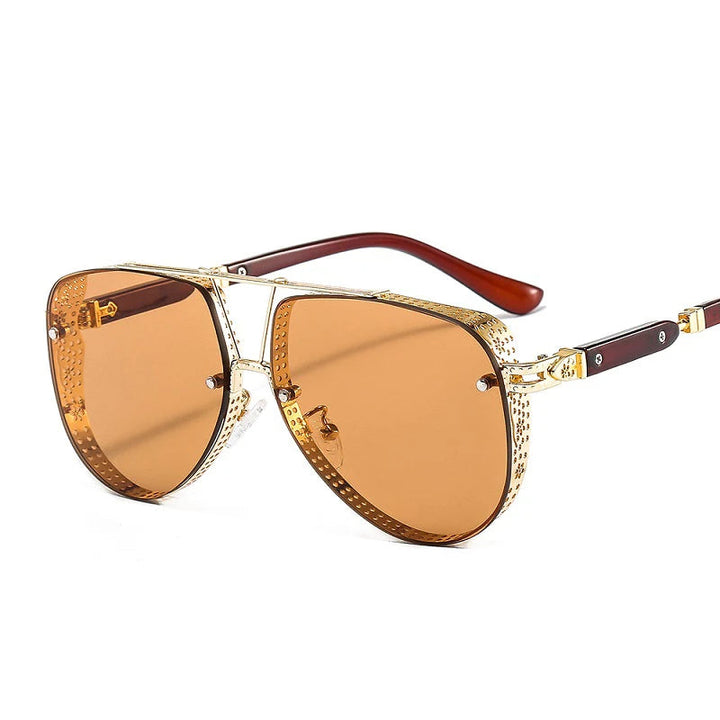 Trendy gold metal oval sunglasses for women resting on a neutral surface