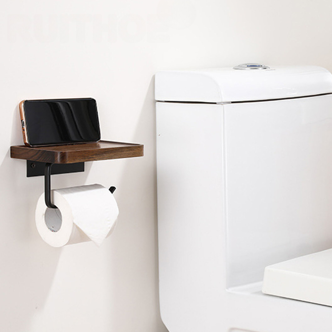 Walnut toilet paper holder installed on bathroom wall next to toilet