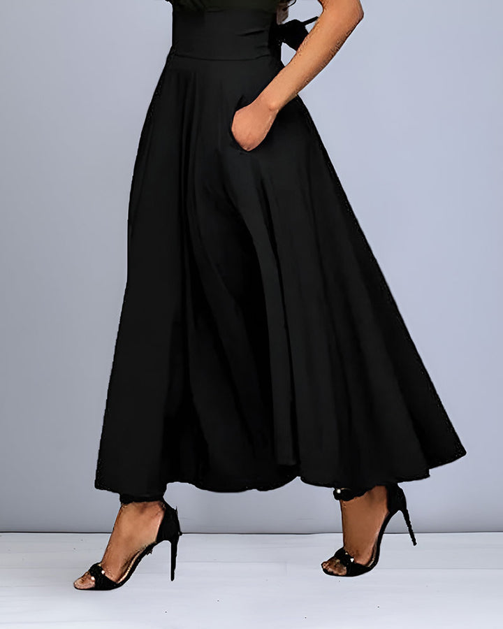 Close-up view of the black high-waisted midi skirt pocket detail