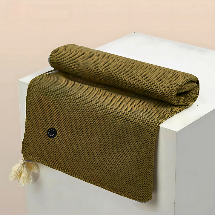 Green cordless USB heated shawl neatly folded on a white display pedestal