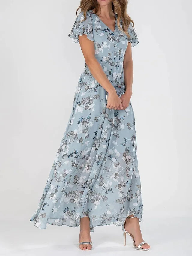 Woman wearing a light blue floral midi dress with short flutter sleeves