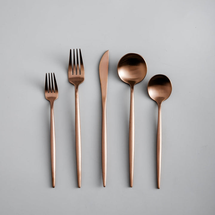 Minimalist stainless steel cutlery set featuring a modern fork, knife, and spoon layout