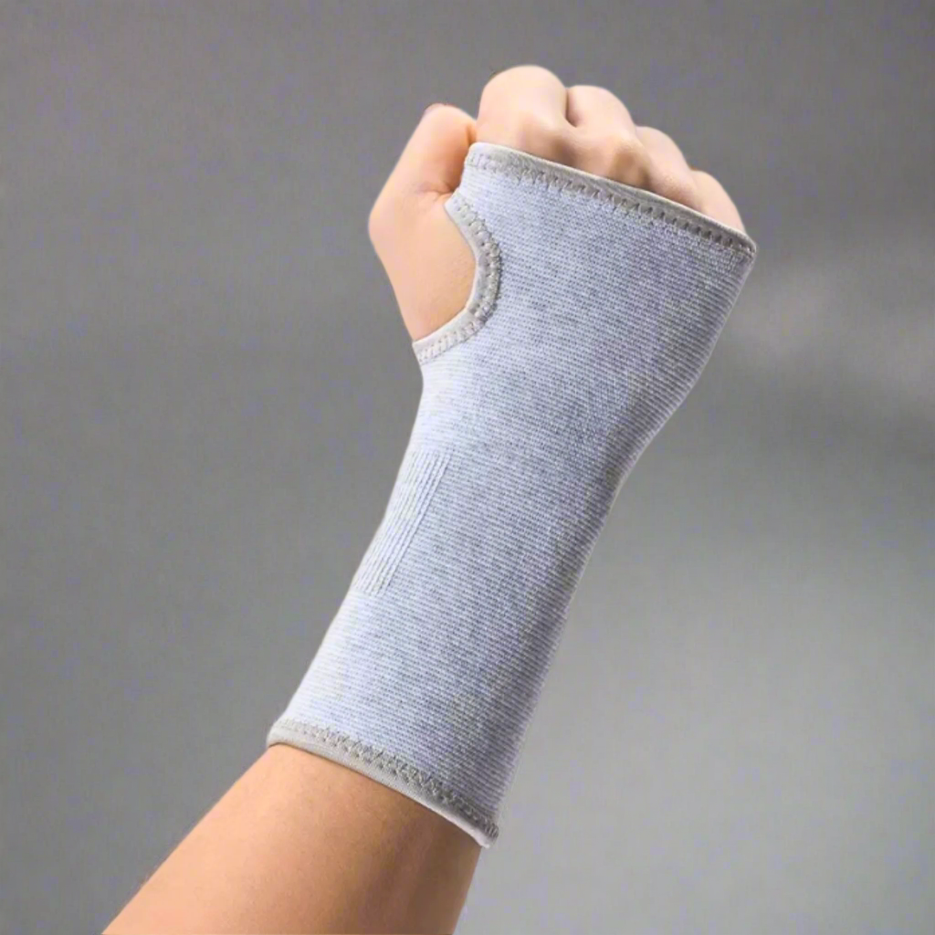 Unisex grey orthopaedic wrist support sleeve worn on hand