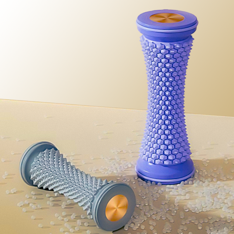 Purple and grey textured foot massage rollers positioned upright and horizontally on a surface