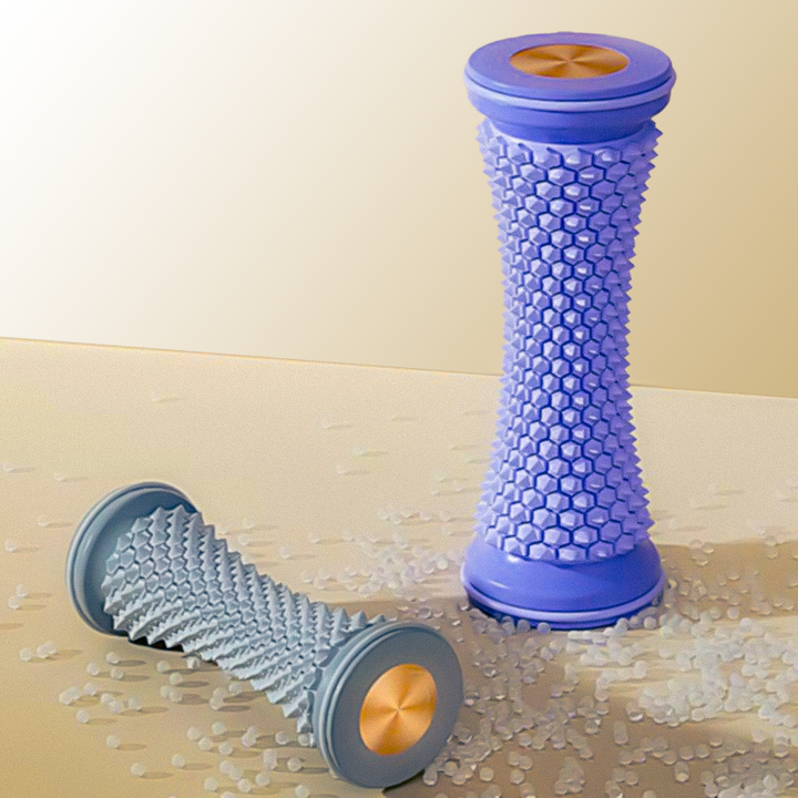 Purple and grey textured foot massage rollers positioned upright and horizontally on a surface