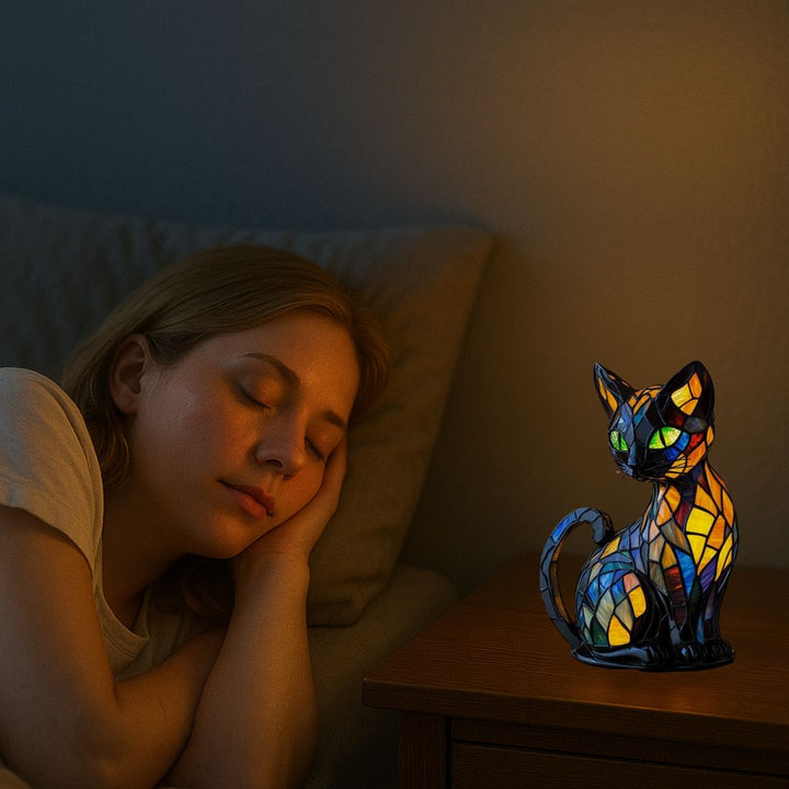 Handmade mosaic glass cat lamp casting colorful patterns as bedroom decor