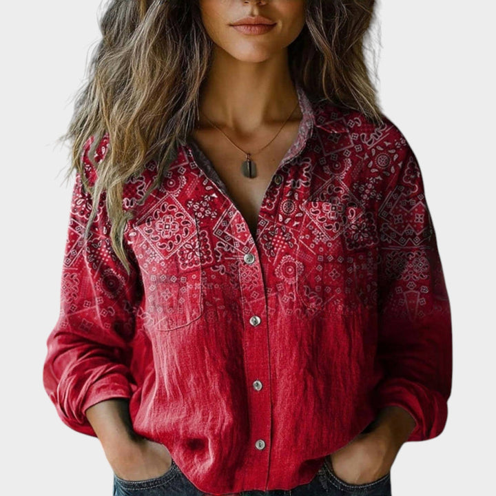 Woman wearing a red patterned vintage button-up blouse with long sleeves