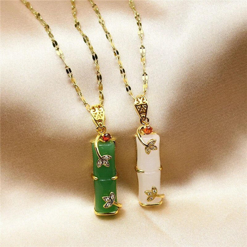 Close-up of green and white gemstone pendants with detailed gold accents