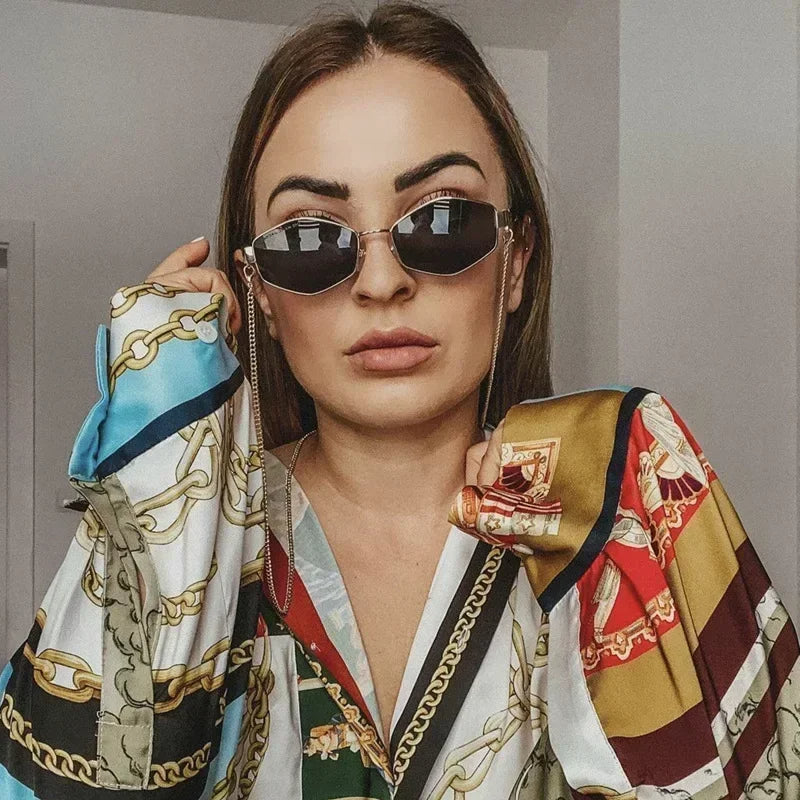 Woman wearing stylish retro chain sunglasses with vibrant patterned blouse