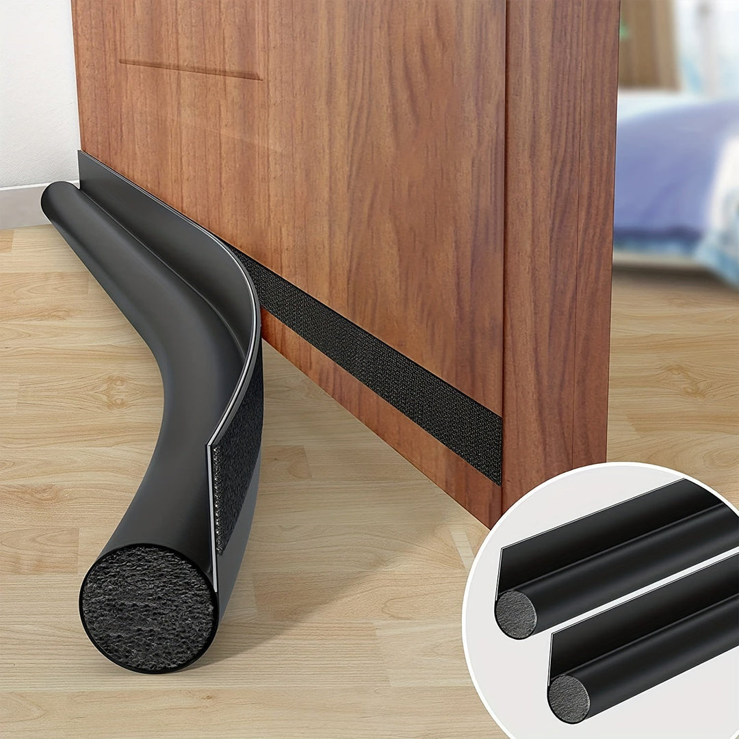 Black door draught excluder installed on a wooden door showing dual rolls