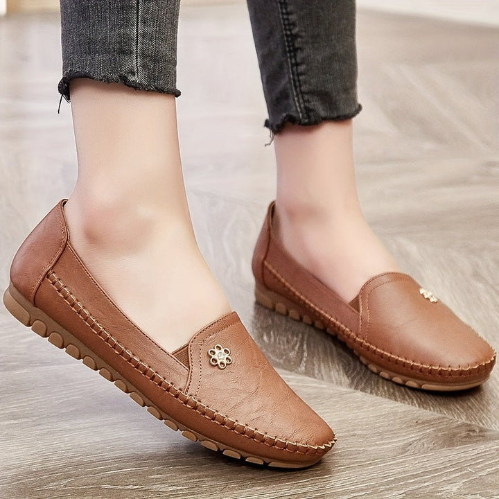 Pair of women's black loafers neatly arranged together, showcasing everyday casual style and comfort.