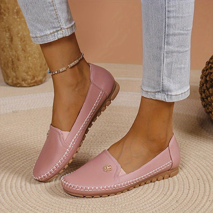 Close-up of pink comfortable slip-on loafers worn on feet