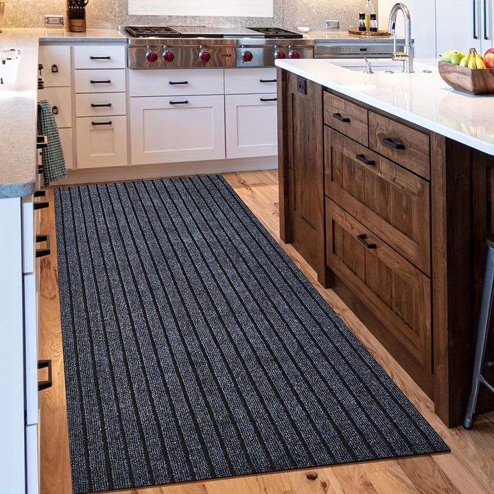 Dark grey striped runner rug styled in a modern kitchen with white cabinets.