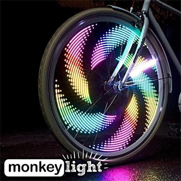 Close up of bicycle wheel glowing with multi-colored LED spoke light patterns