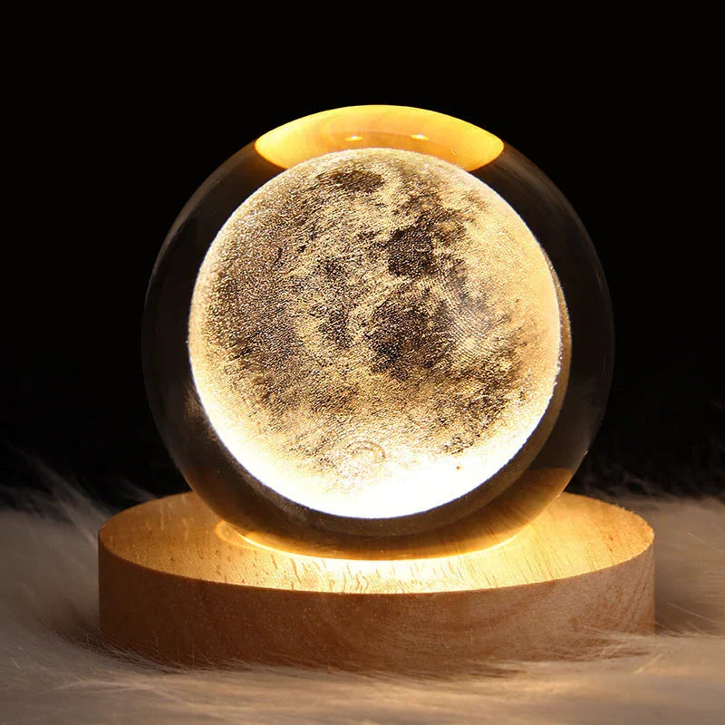 Glowing moon 3D crystal sphere lamp on wooden base in a dark room