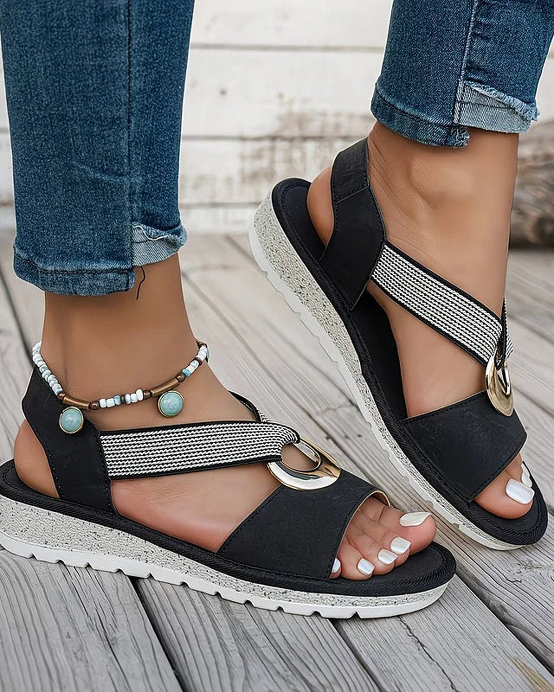 Bottom sole view of women's casual flat sandals showing traction pattern
