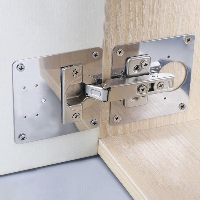 Flat lay of multiple stainless steel hinge repair plates and matching mounting screws