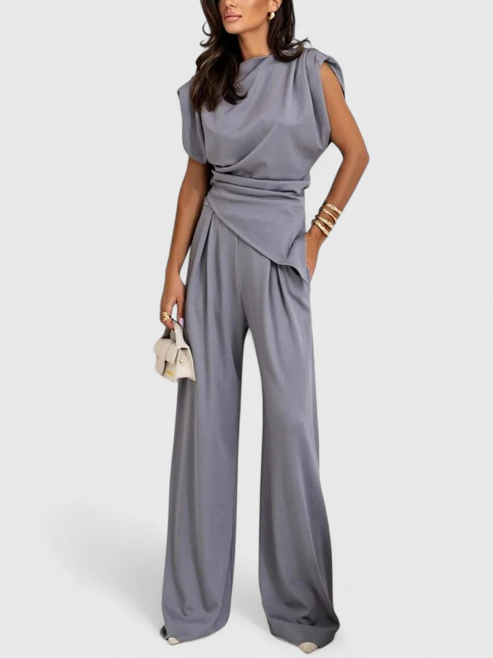 Woman wearing light grey elegant two piece coordinated outfit