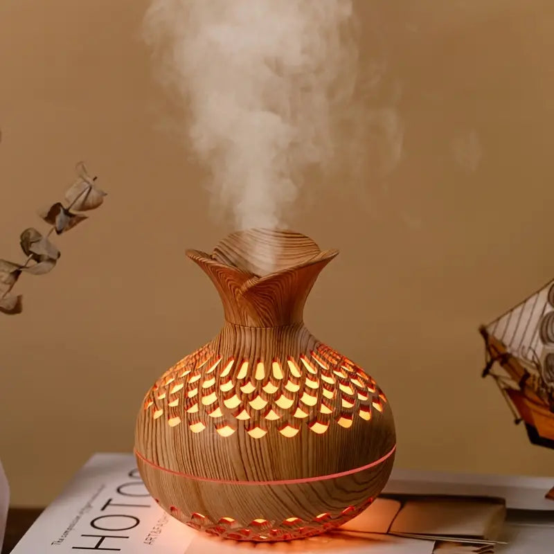 Brown AromaBloom essential oil diffuser releasing mist on a wooden table