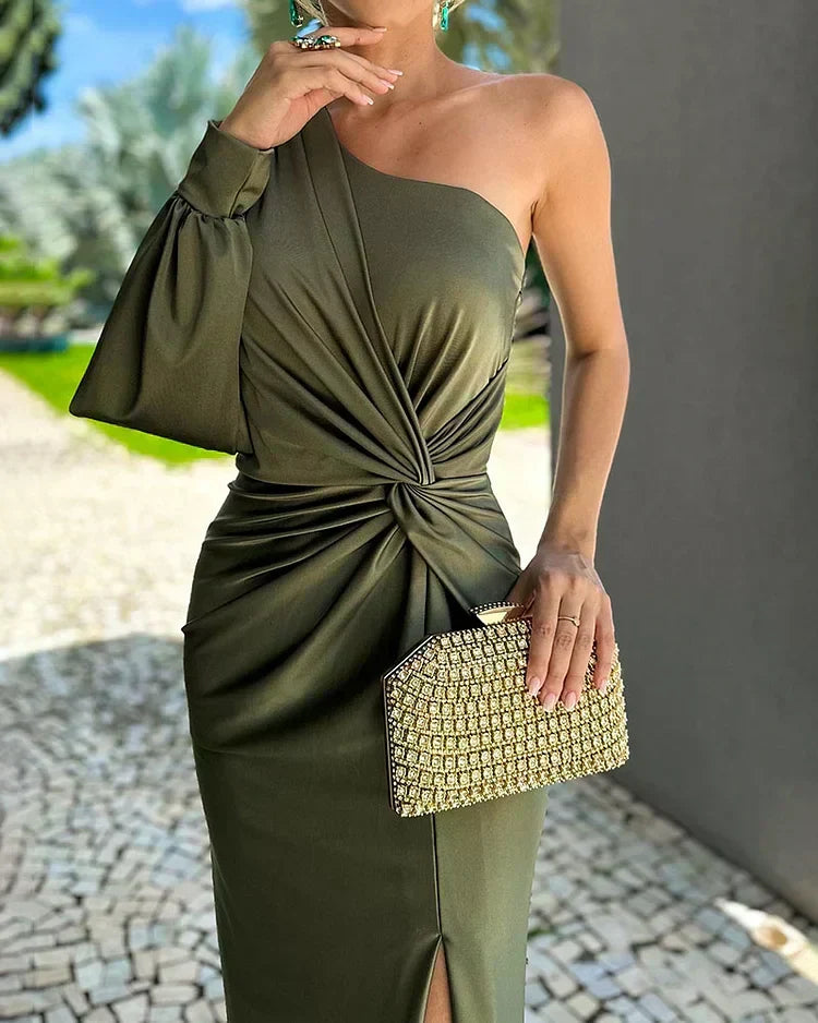 Close-up view of the draped bodice and one-shoulder design in green