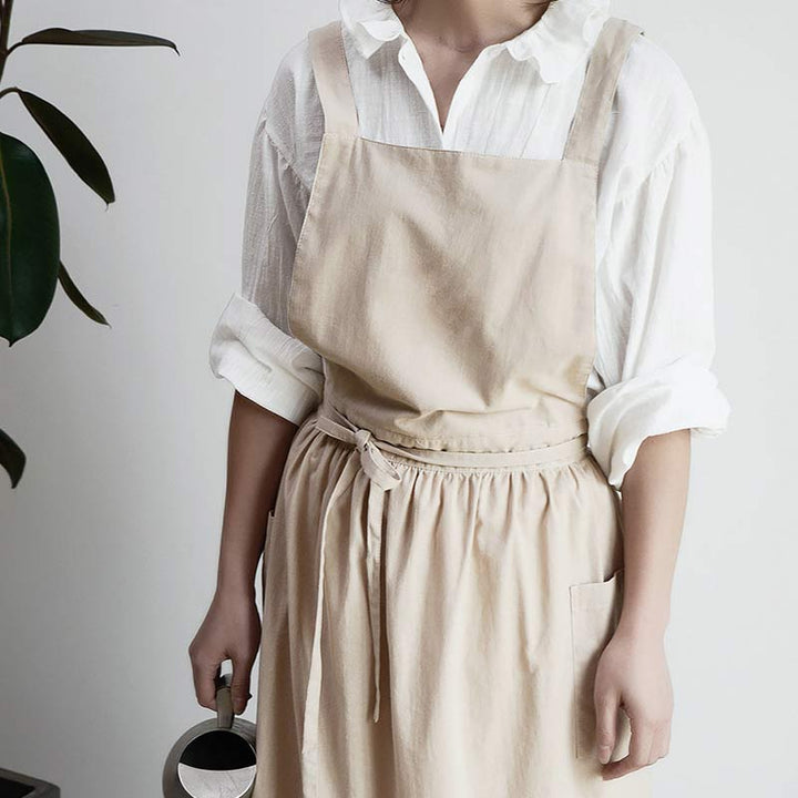 Close-up of deep utility pockets on a pink waterproof chef apron