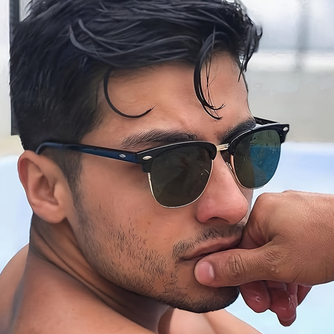 Close-up portrait of a man wearing classic casual sunglasses outdoors