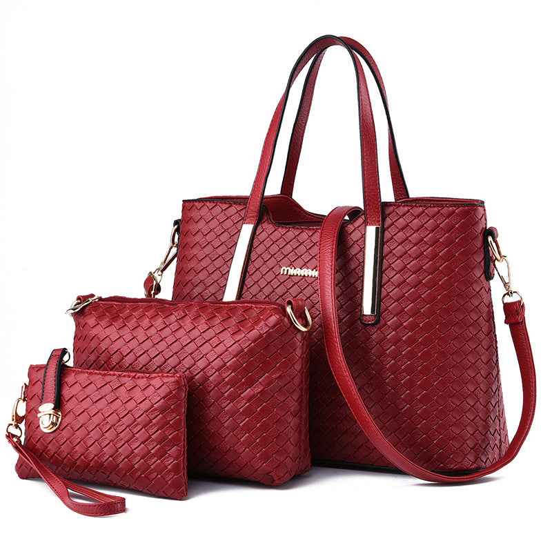 Model holding the stylish red everyday handbag by the top handles, showcasing its versatile wear.