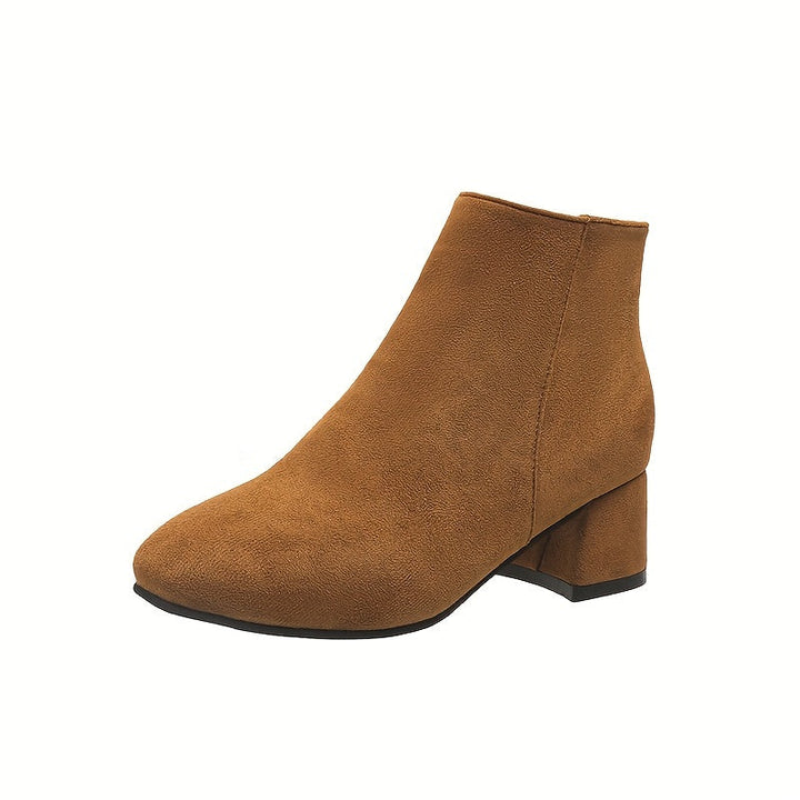 Top-down view of womens black leather chelsea boots with round toe