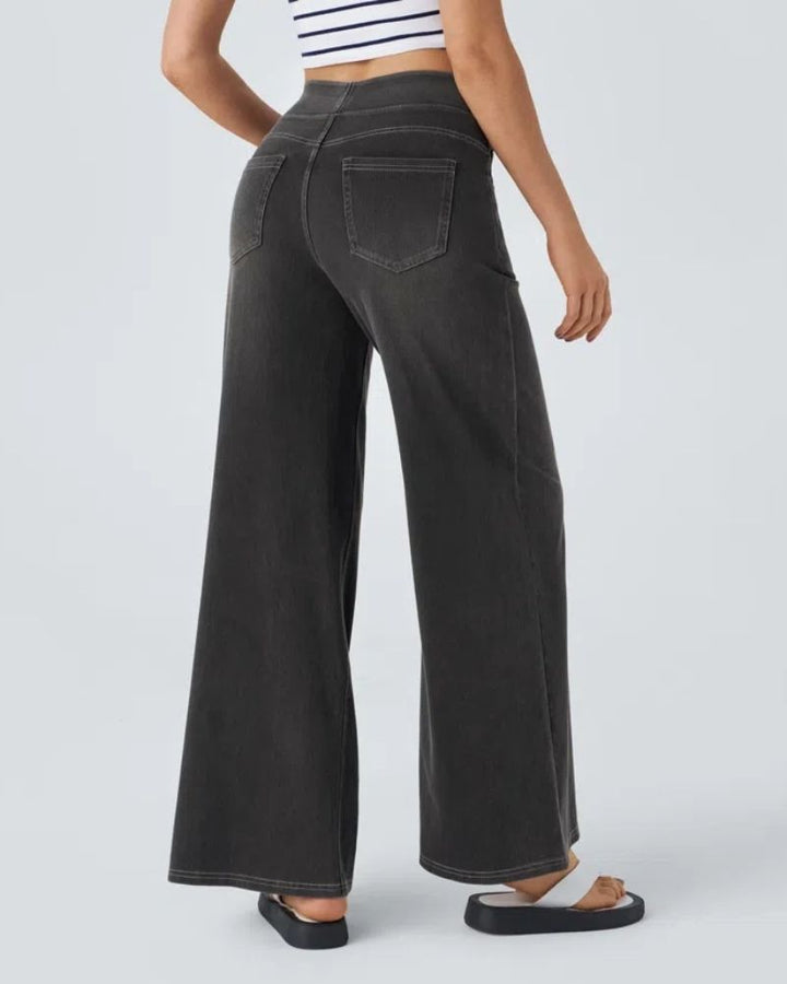 Draped fold detail showcasing the soft fabric of wide-leg trousers